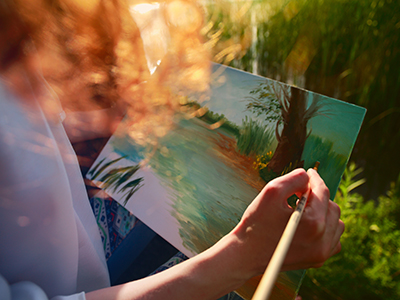 oung woman painting landscape at sunset small