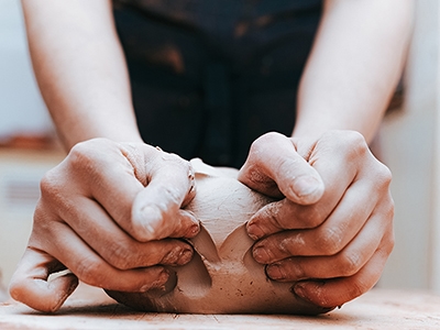 Potter kneads clay in workshop