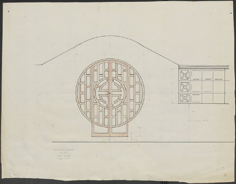 A color drawing of the moon gate design on aged off-white paper. A curved line marks the top of the stone wall which rises to accommodate the perfectly round gate. The gate itself is hand colored red and is make up of rectangles and a central geometric shape. Two rectangles sit at the bottom of the circle to allow for stepping through when the gate is open. Exacting squares are partially drawn in on the right side of the design to show where the stone blocks will begin.